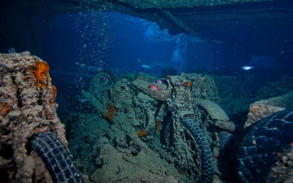 Shipwreck of the S.S. Thistlegorm in the Red Sea, with motorcycles, military equipment, and other artifacts scattered on the seabed