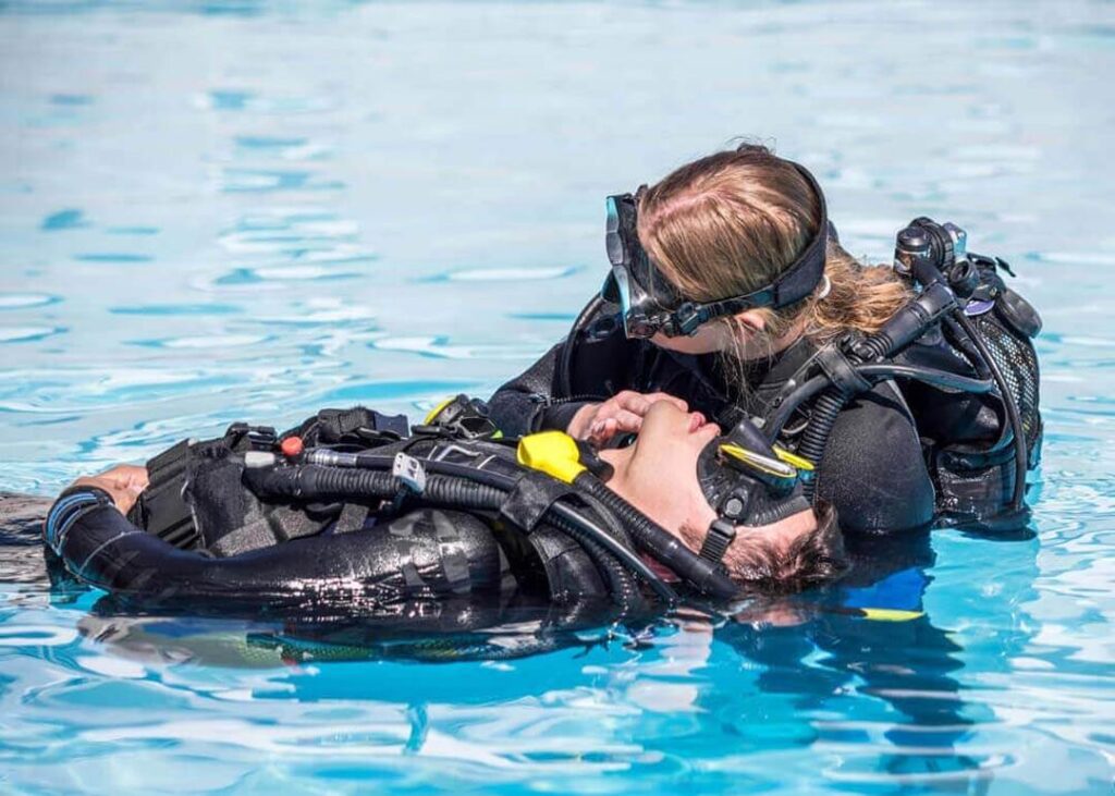 Two divers during rescue training in the swimming pool