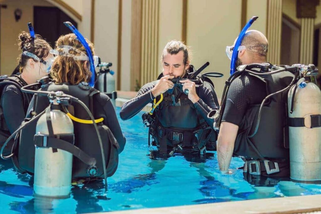 A group of diving trainees during training in the swimming pool.