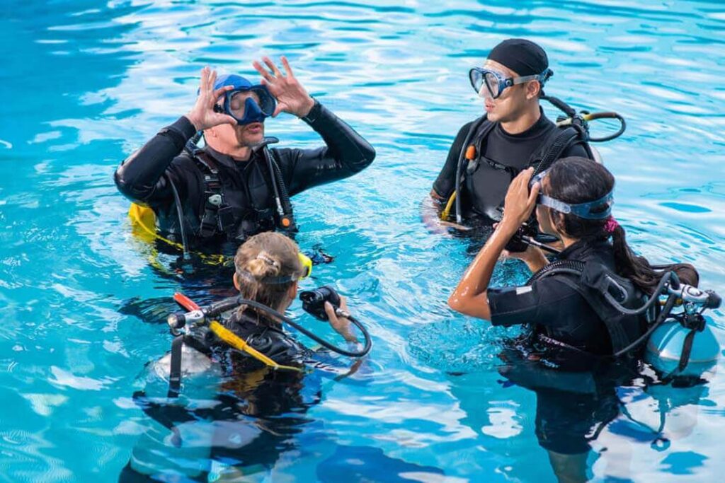 A group of diving trainees during training in the swimming pool.