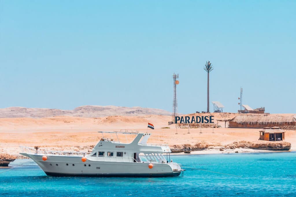 A serene paradise island in Egypt, located in the Red Sea near Hurghada, featuring pristine beaches and lush greenery under a clear blue sky.